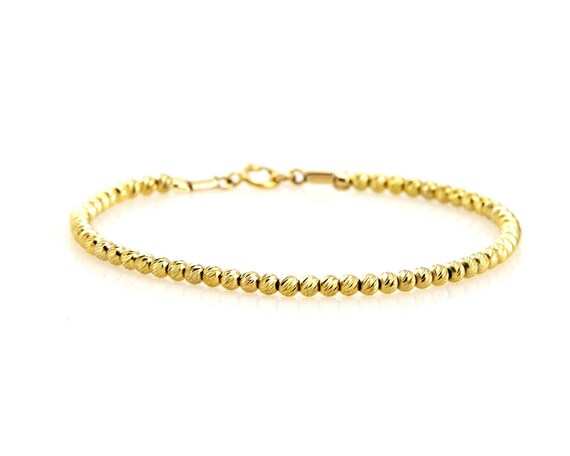 Bracciale in oro giallo 14 carati con quattro fili di perle da 7 pollici e maglie in oro giallo - Italia