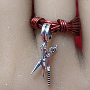Hair salon tools. This charm ring has scissors and comb charms with bronze wire foundation.