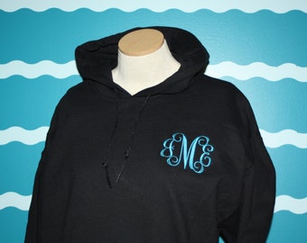 May include: Black hooded sweatshirt with a blue monogrammed "M" on the front.