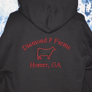 May include: Black hooded sweatshirt with red embroidered text that reads "Diamond P Farms" and "Homer, GA". A black silhouette of a cow is embroidered between the text.