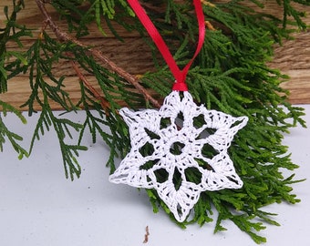 star shaped white snowflake ornament crocheted with silver sparkle