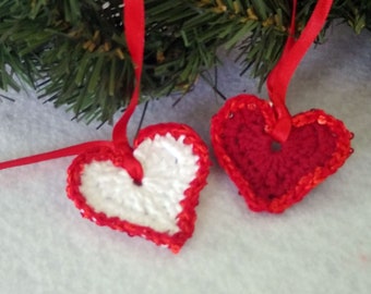 Pair (2) of red and white hearts hand-crocheted with sparkly sequin trim. Quick shipping winter holiday decoration.