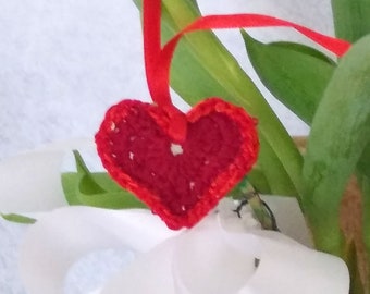 Red crochet valentine heart with sparkly sequin trim hanging on a satin ribbon. Sweet little holiday gift idea for someone you love.