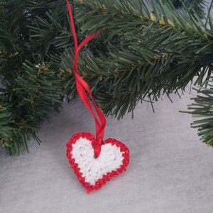 White crochet valentine heart trimmed with red sparkly sequin trim and a satin ribbon. Sweet little holiday gift idea for someone you love. image 6