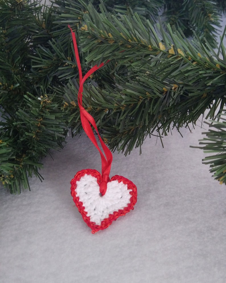 White crochet valentine heart trimmed with red sparkly sequin trim and a satin ribbon. Sweet little holiday gift idea for someone you love. image 6