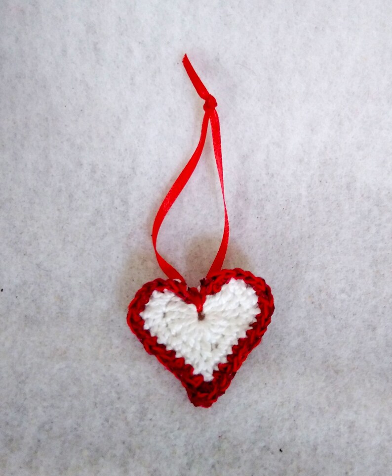 White crochet valentine heart trimmed with red sparkly sequin trim and a satin ribbon. Sweet little holiday gift idea for someone you love. image 8