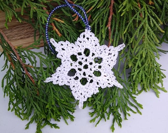 White crochet snowflake ornament with silver sparkle,