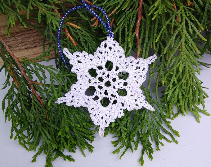 White crochet snowflake ornament with silver sparkle,