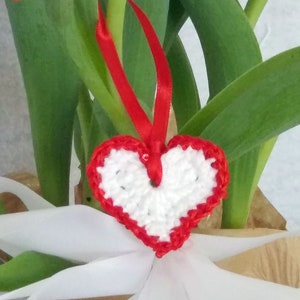 White crochet valentine heart trimmed with red sparkly sequin trim and a satin ribbon. Sweet little holiday gift idea for someone you love. image 1