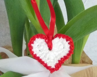 White crochet valentine heart trimmed with red sparkly sequin trim and a satin ribbon. Sweet little holiday gift idea for someone you love.