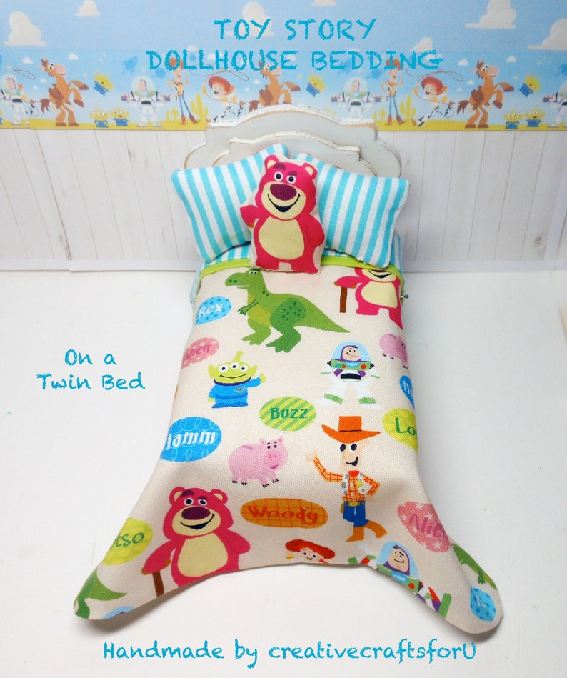 May include: Toy Story dollhouse bedding set with a white background and a colorful print featuring characters like Woody, Buzz Lightyear, and Rex. The bedding set includes a pillow and a comforter with a twin bed size.