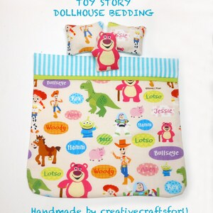 May include: Toy Story dollhouse bedding set with a pink and white patterned duvet cover and two pillows. The duvet cover features characters from the Toy Story movies, including Woody, Buzz Lightyear, Jessie, and Lotso. The pillows are white with a brown border and feature the characters Jessie and Lotso.