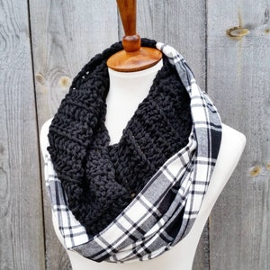 May include: A black crocheted infinity scarf with a white and black plaid fabric lining.
