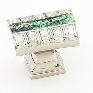 May include: A square cabinet knob with a silver base and a top made of iridescent green and white mother of pearl tiles.