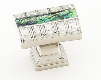 May include: A square cabinet knob with a silver base and a top made of iridescent green and white mother of pearl tiles.