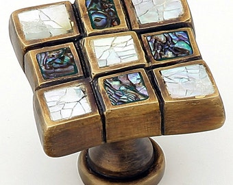 May include: Square cabinet knob with a brass finish and a mosaic of iridescent mother-of-pearl tiles.