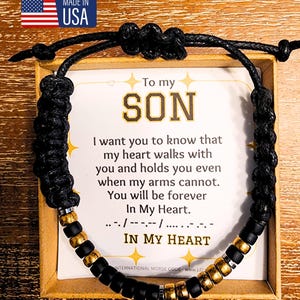 May include: A black and gold beaded bracelet with a message card that reads "To my SON I want you to know that my heart walks with you and holds you even when my arms cannot. You will be forever In My Heart. .../-----/......-.-.- IN MY HEART INTERNATIONAL MORSE CODE www.LOV"