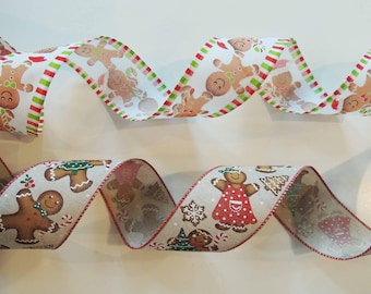 May include: Two decorative ribbons with gingerbread men and holiday designs. One ribbon has a white background with gingerbread men, red and green stripes. The other ribbon has a tan background with gingerbread men, snowflakes, and gingerbread houses.