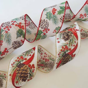 May include: Decorative ribbon with a festive holiday design. The ribbon features a cream-colored background with illustrations of pine cones, holly, and red berries. The edges are trimmed with red and gold accents, perfect for gift wrapping or crafting.
