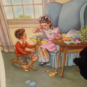 May include: A girl in a pink dress sits in a chair and looks down at a boy holding a yellow toy airplane. The boy is wearing a red shirt and brown pants. There is a small table with a white tablecloth and a doll on the floor.