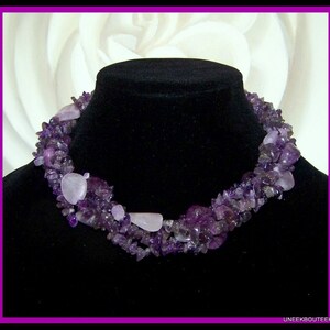 May include: A multi-strand necklace made of amethyst and rose quartz stones. The necklace is made of small, irregular shaped stones and is a beautiful shade of purple.