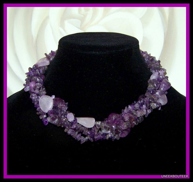 May include: A multi-strand necklace made of amethyst and rose quartz stones. The necklace is made of small, irregular shaped stones and is a beautiful shade of purple.