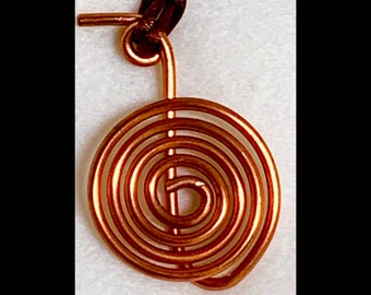 May include: A copper wire spiral pendant with a loop at the top for attaching to a necklace or chain.