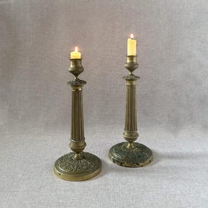Pair of French Empire style antique gilded or brass bronze candlestick holders, ornate neoclassical elegant 19th century candle holders