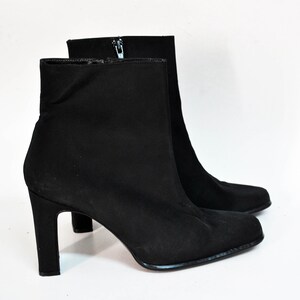 May include: Black ankle boots with a pointed toe and a block heel.