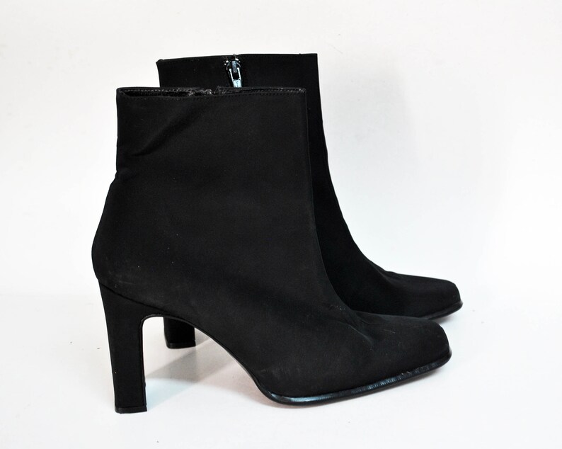 May include: Black ankle boots with a pointed toe and a block heel.
