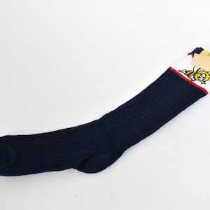 May include: A pair of blue and white striped socks with a yellow bee graphic. The socks have a red stripe at the top and a white cuff.