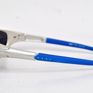 May include: Silver sunglasses with blue rubber arms and mirrored lenses.