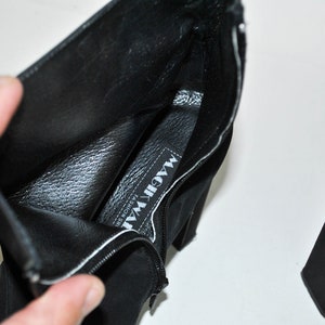 May include: Black suede ankle boots with a zipper on the side and a label inside that reads "MAGIC WAY FASHION SHOES".