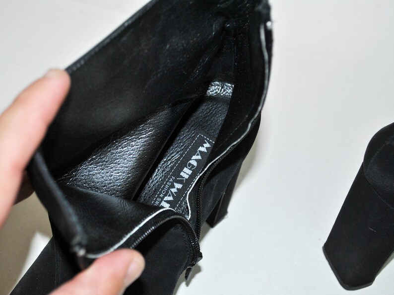 May include: Black suede ankle boots with a zipper on the side and a label inside that reads "MAGIC WAY FASHION SHOES".