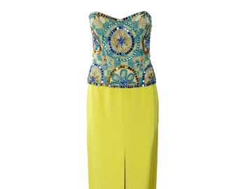 May include: A strapless, beaded, blue and gold top with a yellow maxi skirt. The skirt has a slit in the front.