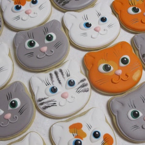 Set of 12 simple, yet cute, smiling cat face cookies. Includes solid and striped gray, orange, white and tabby kitten faces. Perfect hostess or birthday gift for the cat lover!