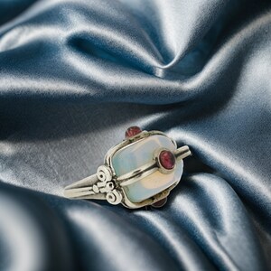 a close up of a ring on a satin material