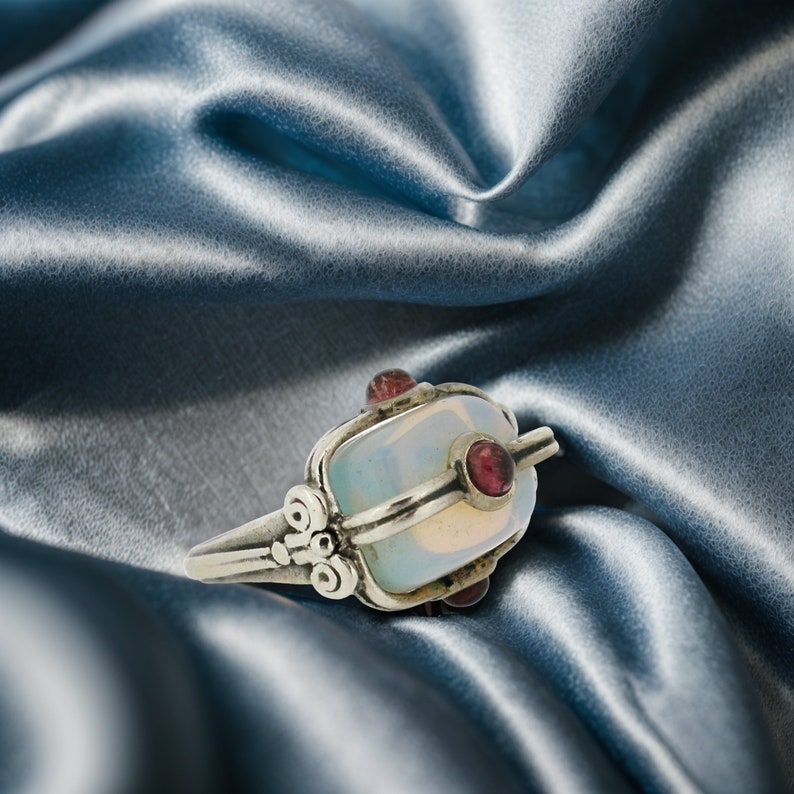a close up of a ring on a satin material