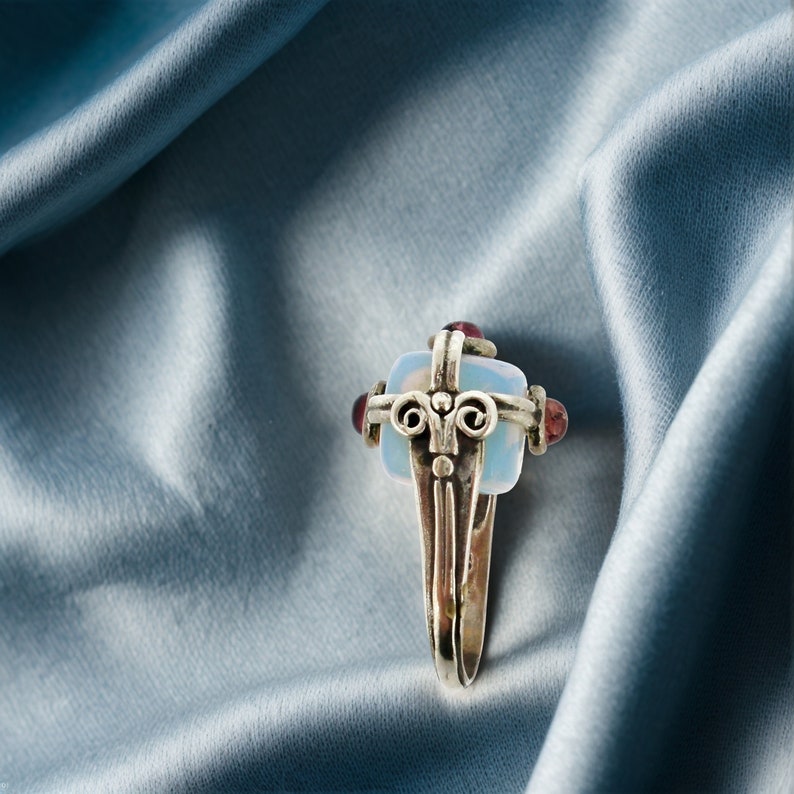 a close up of a brooch on a blue cloth