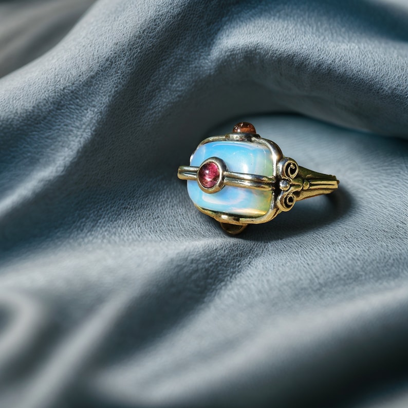 a ring sitting on top of a blue cloth
