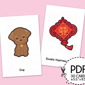 May include: Two white cards with illustrations. One card features a brown cartoon dog with a gold paw print tag and the word "Dog". The other card has a red and black Chinese knot design with the words "Double Happiness".