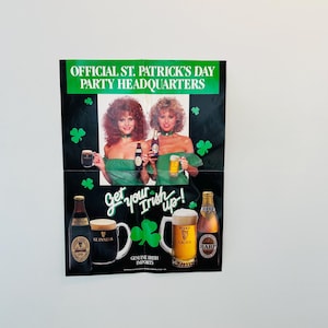 May include: A vintage St. Patrick's Day poster with the text "OFFICIAL ST. PATRICK'S DAY PARTY HEADQUARTERS" and "Get your Irish up!". The poster features two women in green dresses, beer bottles, and mugs of beer.