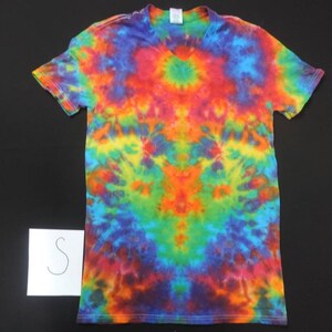 May include: A tie-dye t-shirt with a V-neck and short sleeves. The shirt is a mix of bright colors, including red, orange, yellow, green, blue, and purple.