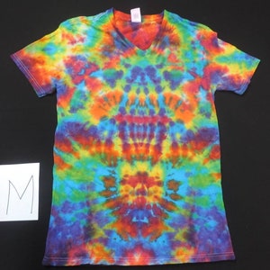 May include: A tie-dye t-shirt with a V-neck and short sleeves. The shirt is a mix of bright colors, including blue, green, yellow, orange, and red. The shirt is size M.