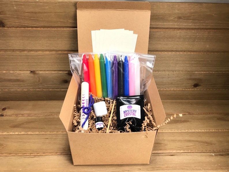 May include: A brown cardboard box filled with a crystal growing kit. The kit includes a small bag of crystals, a small bottle of liquid, a small white container, a wooden stick, a small bag of rainbow colored candles, a small bag of white candles, and a small bag of white paper.