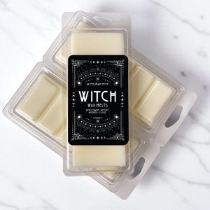 May include: Several wax melt packages are displayed, each containing rectangular wax pieces. The packages are clear plastic, and the wax is a creamy off-white color. A black label on the front reads "Witch Wax Melts" with additional text and decorative elements.
