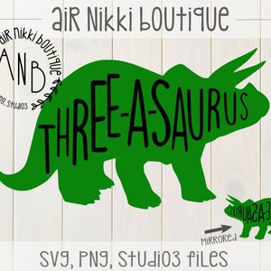 May include: Green silhouette of a three-horned dinosaur with the text "THREE-ASAURUS" on the body. A smaller green dinosaur silhouette is mirrored below the larger dinosaur. The text "MIRRORED" is below the smaller dinosaur. The text "SVG, PNG, Studio3 files" is at the bottom of the image.