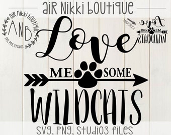 May include: Black and white graphic design with the text "Love Me Some Wildcats" and a paw print in the middle of an arrow. The text "Air Nikki Boutique" is at the top of the design.