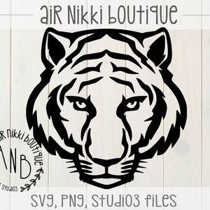 May include: Black and white silhouette of a tiger's head with a floral wreath around the text "Air Nikki Boutique" and "ANB" inside the wreath.