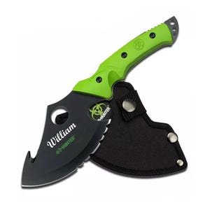 May include: A black and green zombie hunter axe with a black sheath. The axe has a serrated blade and a green handle with a biohazard symbol. The sheath has a snap closure and a belt loop. The axe is personalized with the name "William".